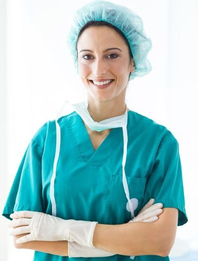 confident-female-medical-worker-wearing-hat-and-mask-looking-to